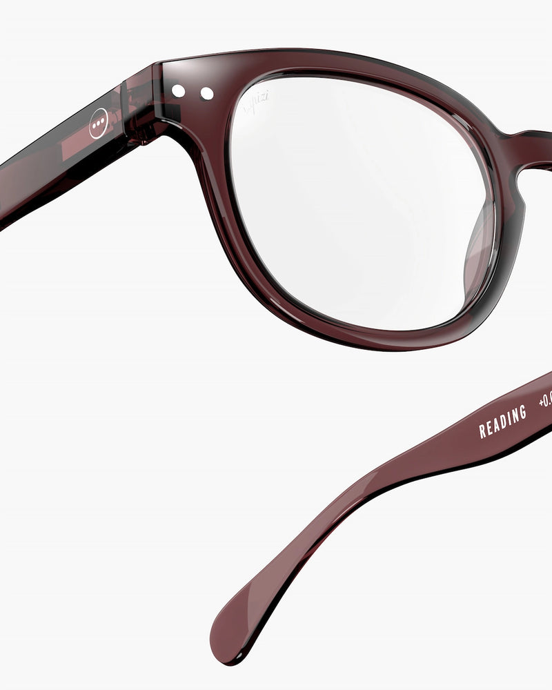 Close-up of a pair of brown eyeglasses on a white background