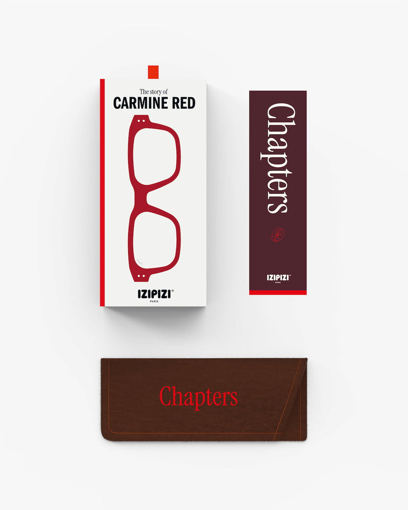 Red glasses with packaging and brown case on a white background