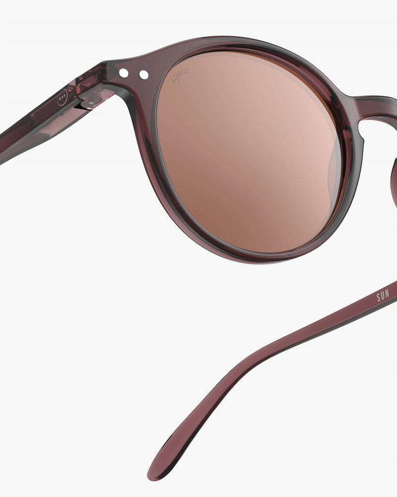 Sunglasses with brown lenses and maroon frame on a white background