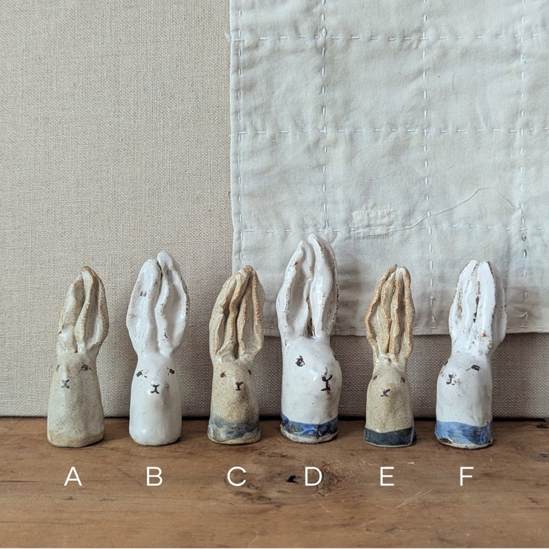 Six ceramic rabbit figures labeled A to F on a wooden surface with a neutral background.

Handmade and hand-painted rabbit head sculptures figurines by Charlotte salt small business sowa Boston gift shop boutique store