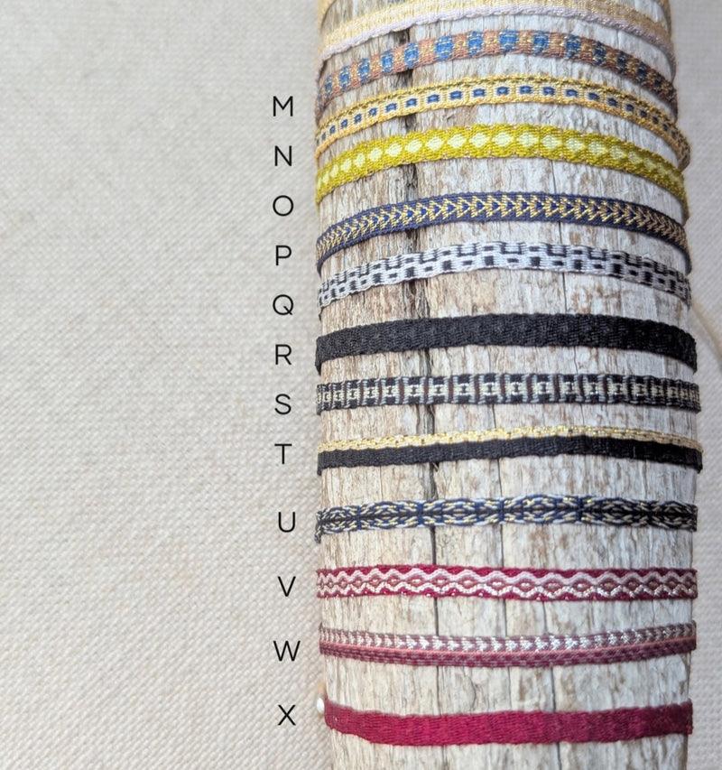 Collection of colorful woven bracelets on a textured surface.

Guanabana woven bracelet jewelry store sowa boston gift shop small business boutique small gifts for her 