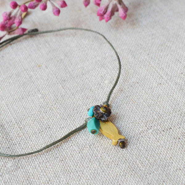 Golden fish bracelet with pearl and turquoise beads. 7" adjustable nylon cord jewelry River Song Shop Boston