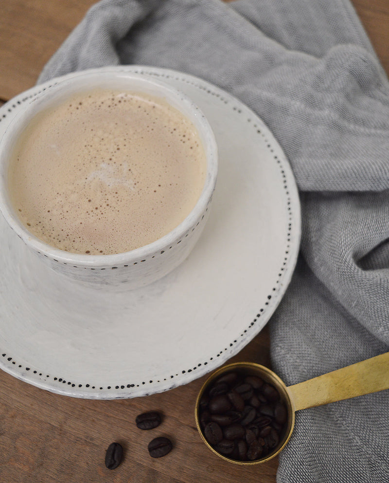 Adorable bowl and matching saucer by French artist Florence Penault. Sized perfectly for ice cream, a cup of soup, or a dip! Tiny hand painted black dots adorn the edges adding a touch of sophistication to the organic look of the glaze.Handmade cup and saucer with black dots. Shop Boston