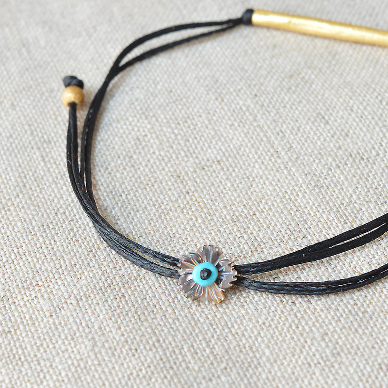 Gold bar bracelet with black cord. 7" adjustable cord. 