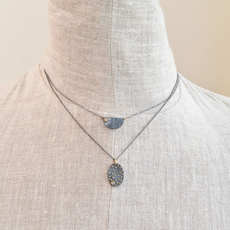 Nikki Nation oxidized silver and 18K gold acrux necklace. 