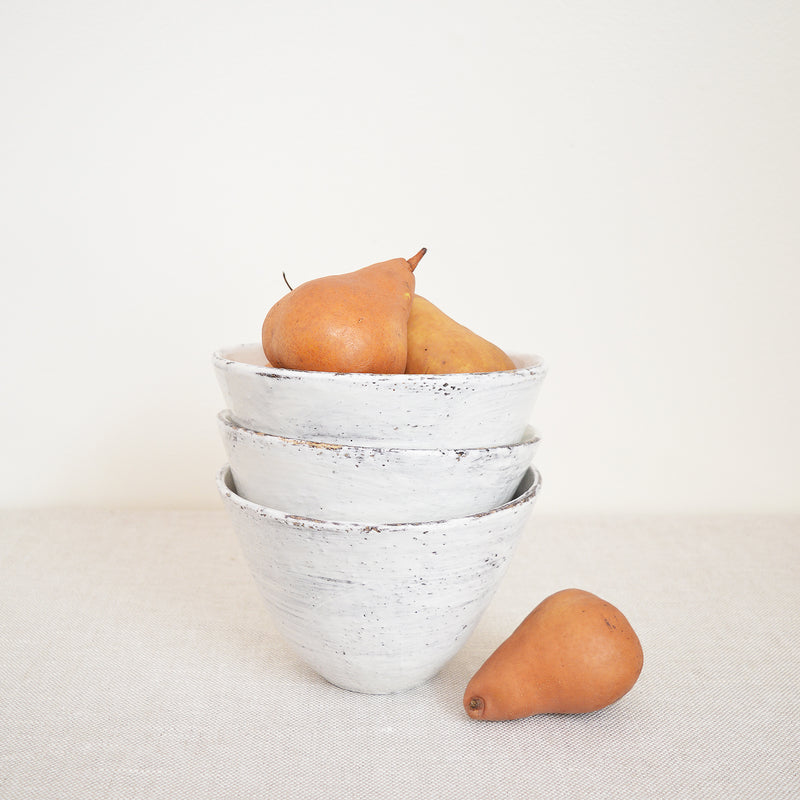 Tall white bowls by Boston artist Florence Penault. Ideal for eating ramen or a big salad but they also make good serving bowls for a side dish.