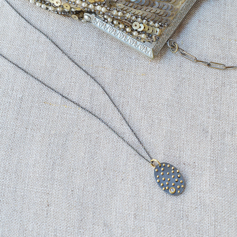 Nikki Nation oxidized silver and 18K gold acrux necklace. 