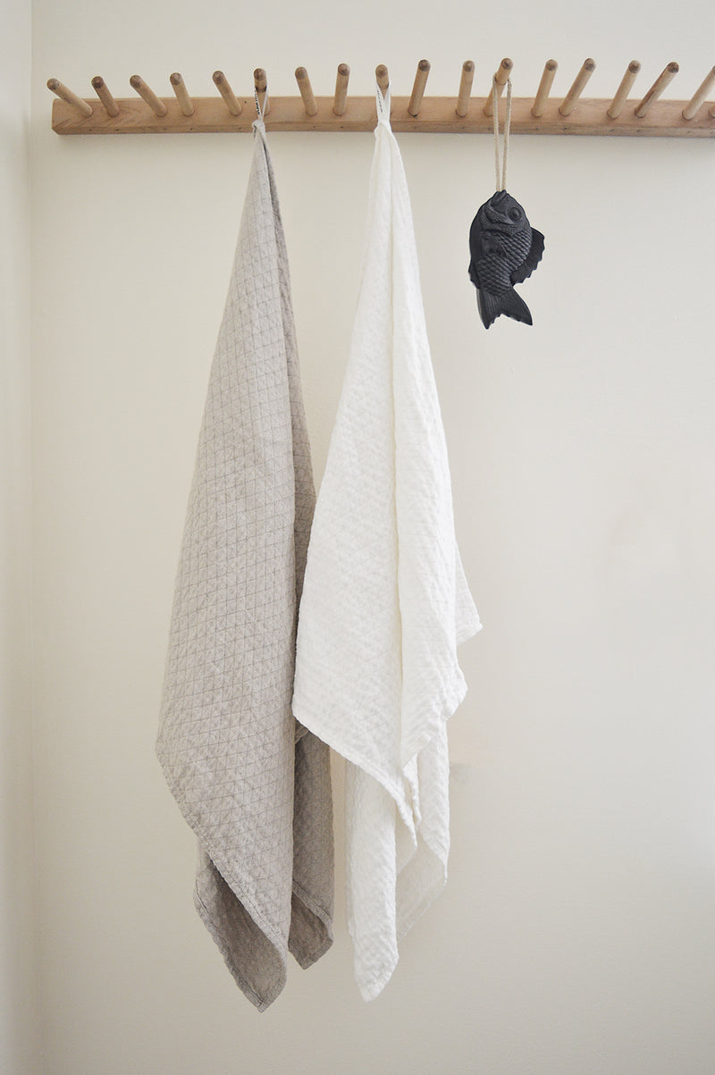 Wonderfully textured for gentle exfoliation and maximum absorbency, these quick-drying and durable diamond weave  towels are  woven from two layers of medium-weight, undyed 100% linen yarns. Whitened without the use of chlorine bleach.  Towels will arrive pressed and take on a quilted appearance after machine wash and dry, becoming softer with use.  For greater exfoliation, hang to dry.