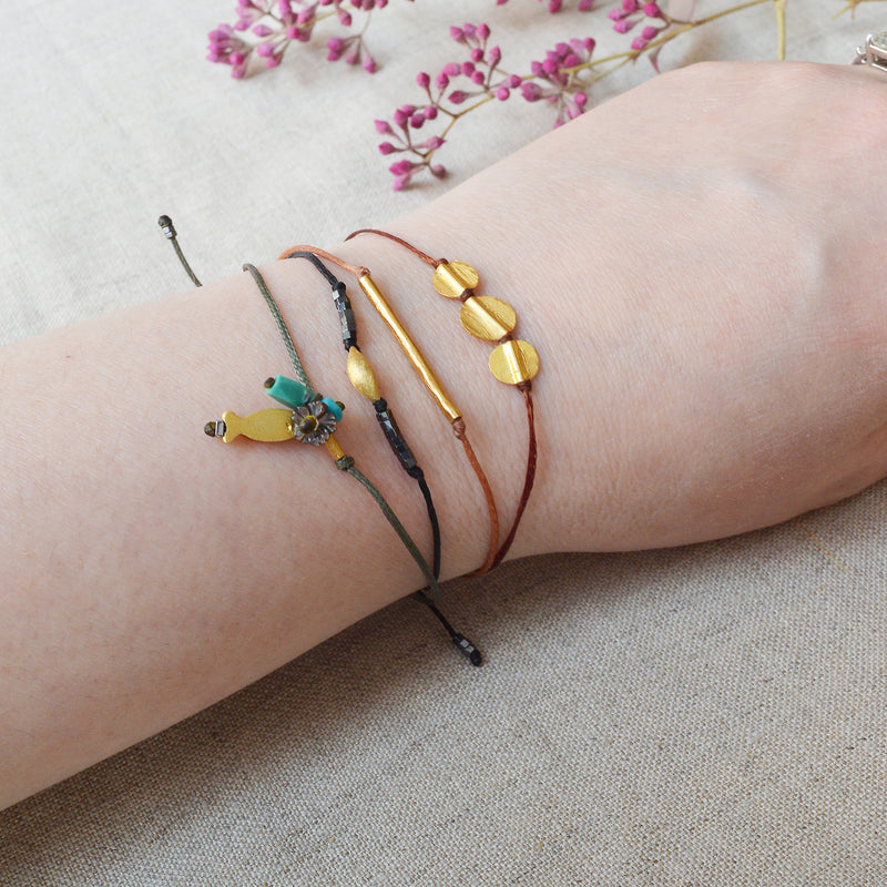 Gold bar bracelet with black cord. 7" adjustable cord. 
