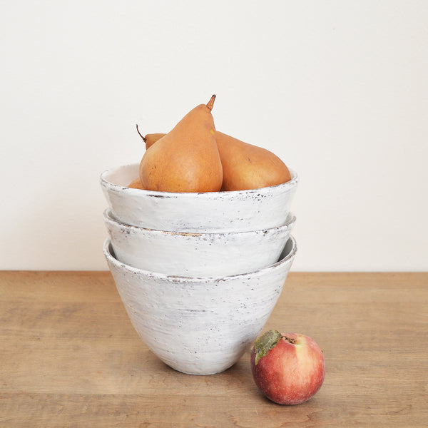 Tall white bowls by Boston artist Florence Penault. Ideal for eating ramen or a big salad but they also make good serving bowls for a side dish.