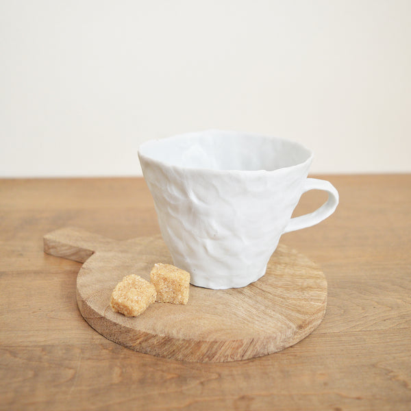 Hand pinched porcelain teacup by Maine potter Ingrid Bathe. Available in Boston shop.