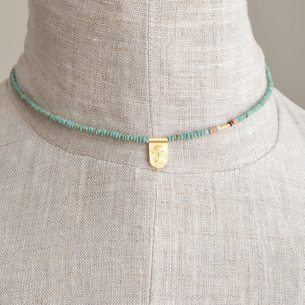 Tab Talisman on Tiny Turquoise Bead Necklace with Black Diamond Detail