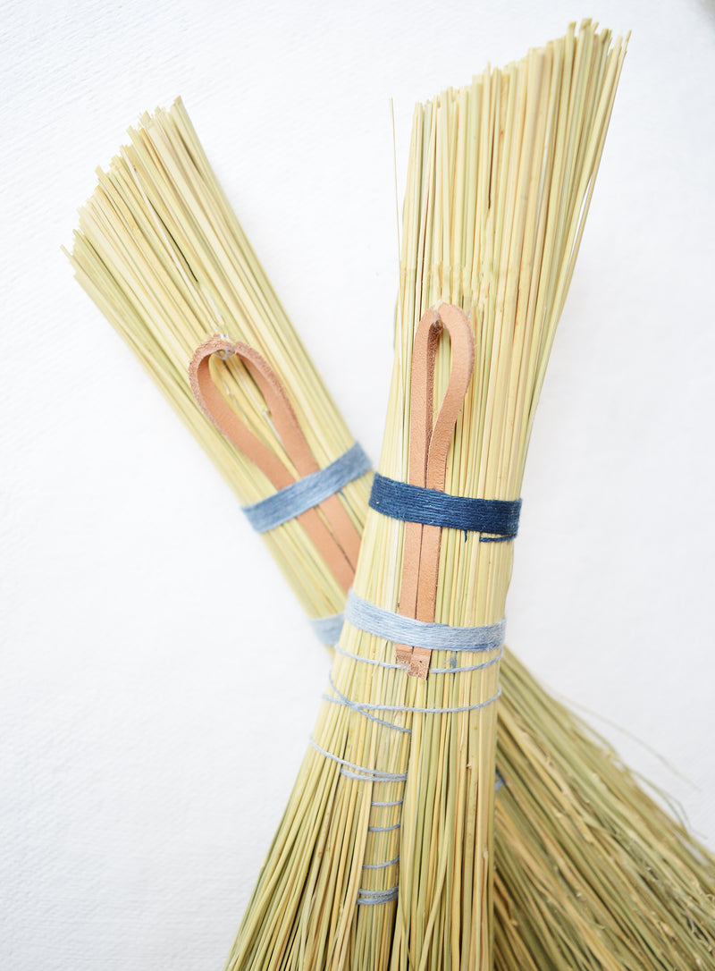 Simple hand broom with contrasting blue and grey linen ties. Handmade in Kentucky by designer/maker Cynthia Main of Sunhouse Craft.