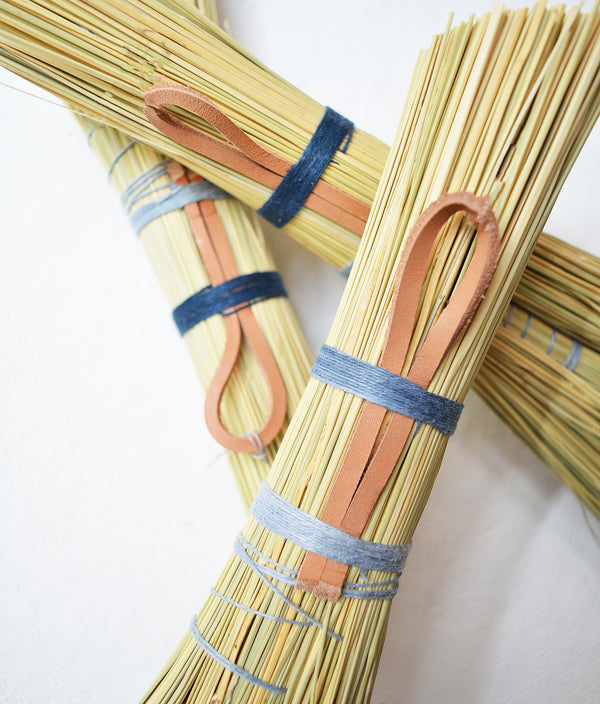 Simple hand broom with contrasting blue and grey linen ties. Handmade in Kentucky by designer/maker Cynthia Main of Sunhouse Craft.
