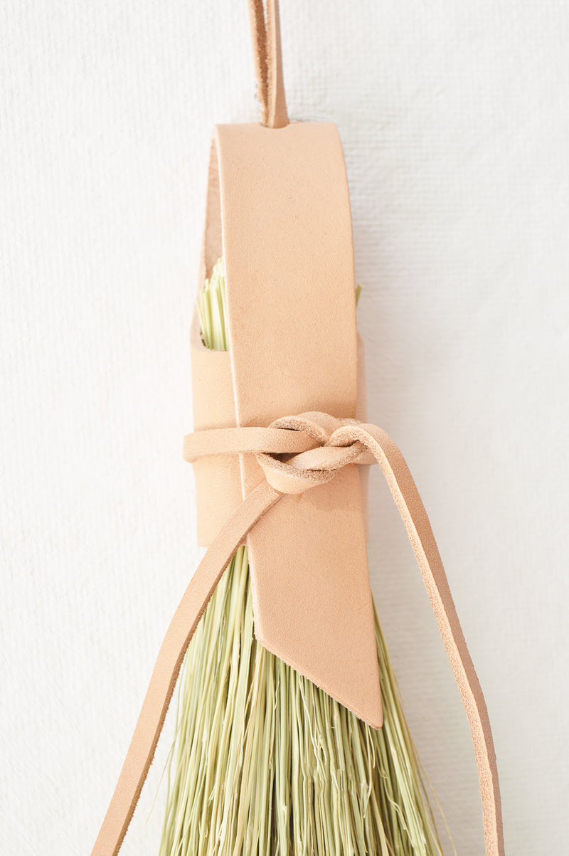 Simple broom wrapped in natural veg tan leather.  Handmade in Kentucky by designer/maker Cynthia Main of Sunhouse Craft.  
