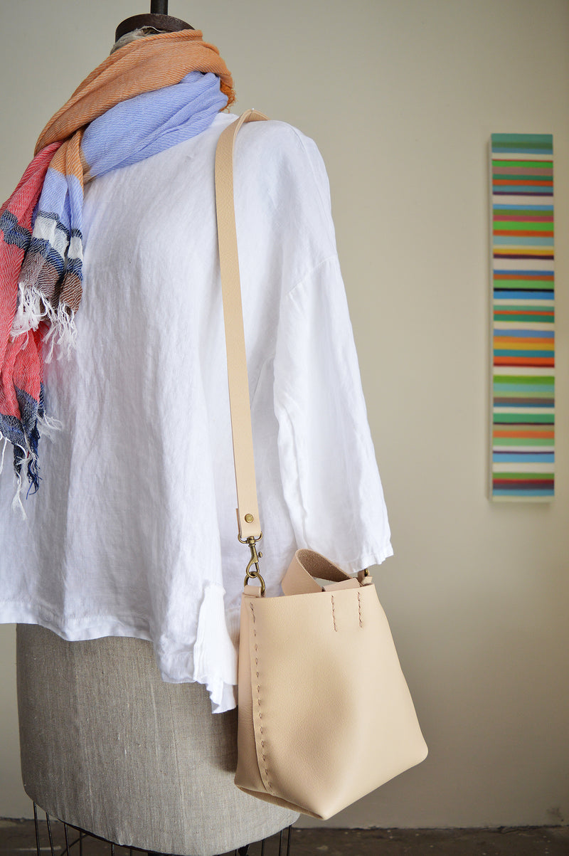 Stitch and Tickle mini bucket tote handmade of soft, medium weight, vegetable tanned leather. The leather will darken beautifully with age. Hand sewn. Made in Boston.