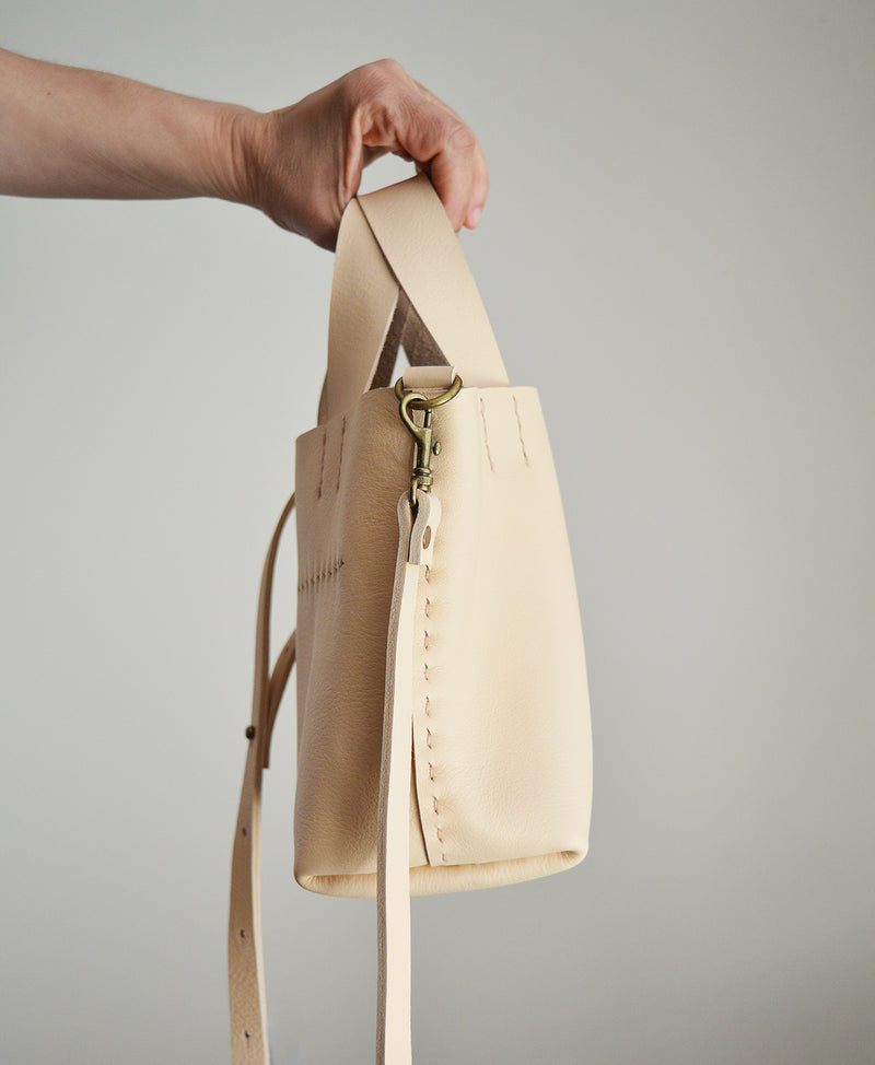 Stitch and Tickle mini bucket tote handmade of soft, medium weight, vegetable tanned leather. The leather will darken beautifully with age. Hand sewn. Made in Boston.