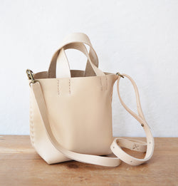 Stitch and Tickle mini bucket tote handmade of soft, medium weight, vegetable tanned leather. The leather will darken beautifully with age. Hand sewn. Made in Boston.