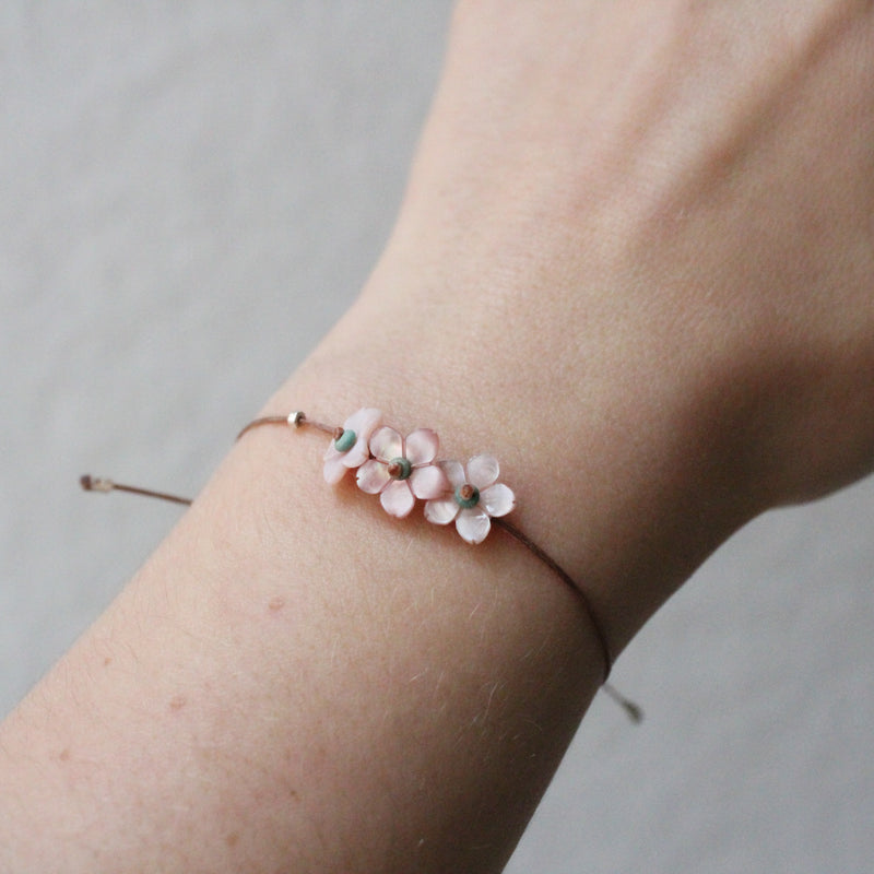 Pink garland bracelet with adjustable cord. flowers Shop Boston