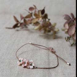Pink garland bracelet with adjustable cord. flowers Shop Boston