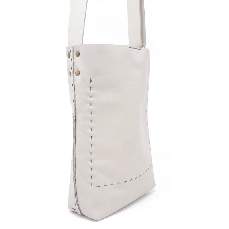 The Molly is the perfect travel bag. It easily fits a small water bottle, a tablet, wallet and glasses. Can be worn over the shoulder or as a crossbody. Adjustable strap.