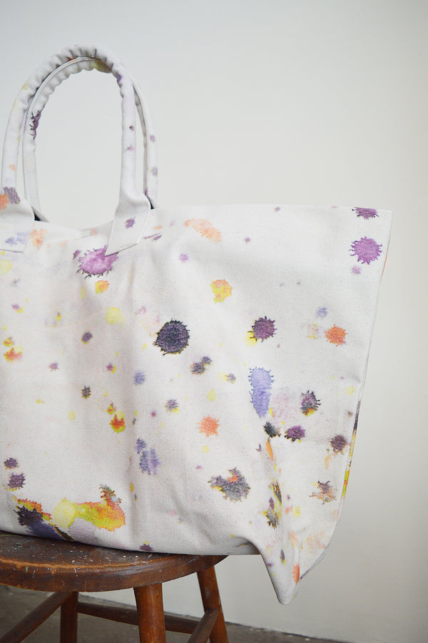 Martyn Thompson oversized canvas tote bag with paint splatter printed design. Carryall, extra large totebag available in Boston Shop. The newest version of our popular drop cloth canvas bag! Perfect for a day at the beach, a weekend getaway, or running about the city. 
