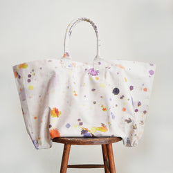 Martyn Thompson oversized canvas tote bag with paint splatter printed design. Carryall, extra large totebag available in Boston Shop. The newest version of our popular drop cloth canvas bag! Perfect for a day at the beach, a weekend getaway, or running about the city. 